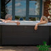 Oslo-6-Person-Hot-Tub-with-Couple-Relaxing-in-Backyard